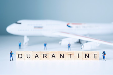 Group of toy people isolate a plane and its passengers. Quarantine concept.