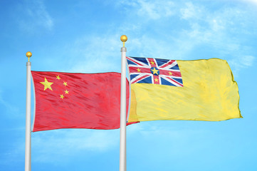 China and Niue two flags on flagpoles and blue cloudy sky