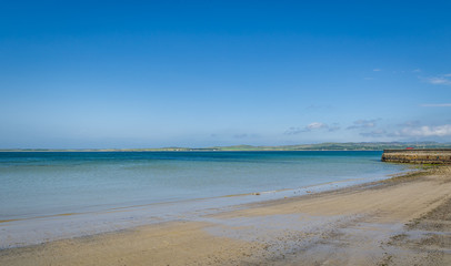 Bowmore beautiful beach with nobody and perfect ocean water. Islay island, Scotland.