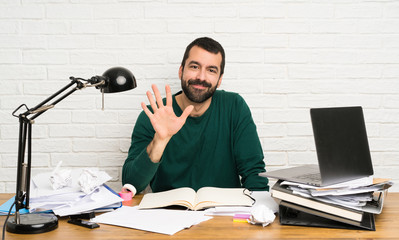 Student man counting five with fingers