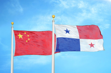 China and Panama two flags on flagpoles and blue cloudy sky