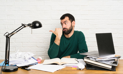 Student man unhappy and pointing to the side