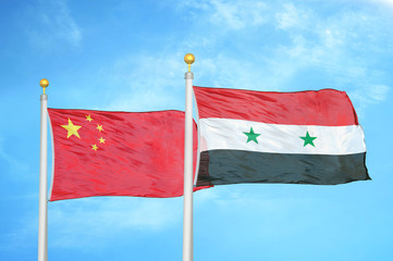 China and Syria two flags on flagpoles and blue cloudy sky
