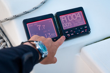 Modern sailing yacht controls - tridata and autopilot displays, showing speed, depth and course. Scotland sailing trip.
