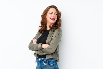 Young Russian woman over isolated white background with arms crossed and happy