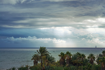 view from the shore to storm clouds over the sea