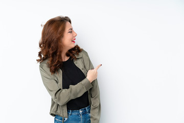Young Russian woman over isolated white background pointing back