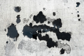 Stains of car oil drips and spots on concrete