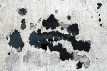 Stains of car oil drips and spots on concrete