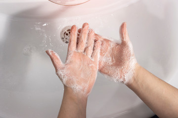 Fototapeta premium Close-up of a girl washing her hands with antibacterial soap. Concept hygiene