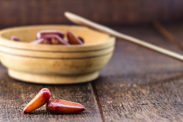 Typical araucaria seeds used as a condiment in Brazilian cuisine in winter. Brazilian pine in rustic brown wooden bowl. Healthy and organic food.