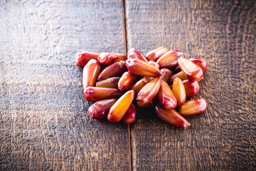 Typical araucaria seeds used as a condiment in Brazilian cuisine in winter. Brazilian pine in rustic brown wooden bowl. Healthy and organic food.