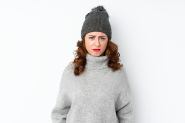 Young Russian woman with winter hat over isolated white background sad
