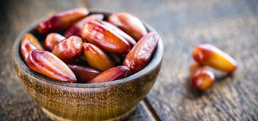 many pine nut seeds in rustic wooden bowl. Typical Brazilian food during the winter.