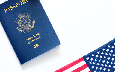 American passport and United States flag on white background. Citizenship and immigration background concept. 