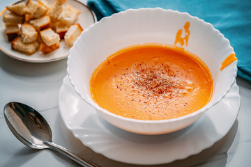 plate with traditional borscht (beetroot soup) on wooden table.