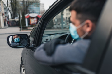 Man in the medical mask and rubber gloves for protect himself from bacteria and virus while driving a car. masked man in a car. coronavirus, disease, infection, quarantine, covid-19
