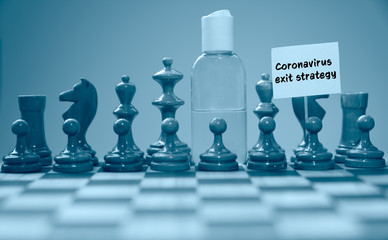 Coronavirus concept image chess pieces and hand sanitizer on chessboard illustrating global struggle against novel covid-19 outbreak with coronavirus exit strategy sign.