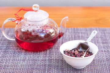cup of tea with spoon of herbs 
