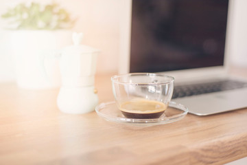 Morning Coffee. Working From Home.  Cup Of Coffee And Italian Coffee Maker In Blue. Bright And Clean Modern Minimalist Kitchen, Close Up. Laptop, Green Succulent Pot On Wooden Worktop. Glare, sun haze