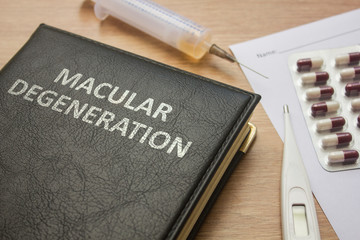 Book about Macular degeneration and medication, injection, syringe and pills