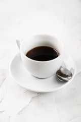 White cup of americano on a white background