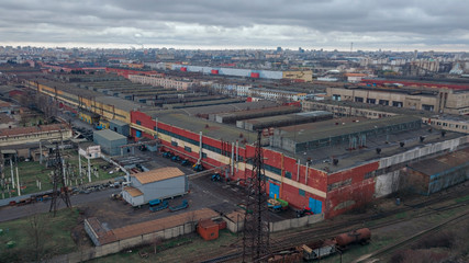 Aerial view of new tractor warehouse storages or industrial factory. Top view of industrial buildings and tractors. Industrial concept.