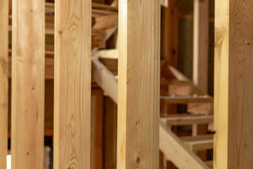 The structure of the new frame house. Close-up of wooden structures. Selected focus
