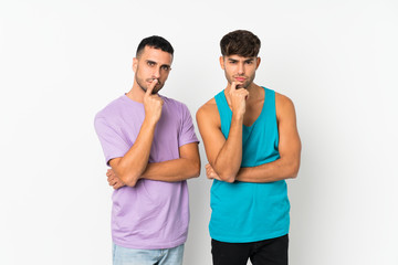 Two men over isolated background smiling and looking to the front with confident face
