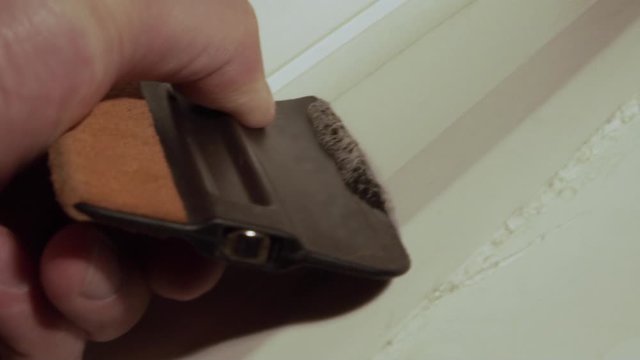 hand scraper removes glue from the surface
