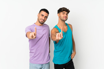 Two men over isolated background showing and lifting a finger