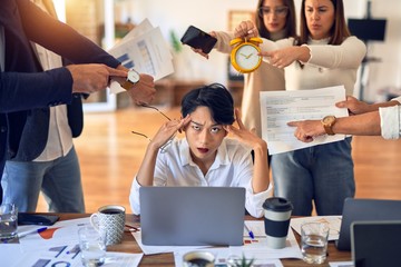 Group of business workers working together. Partners stressing one of them at the office