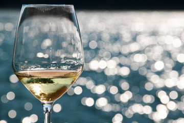 Close-up wineglass and blue sea