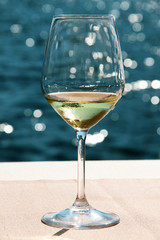 Close-up wineglass and blue sea