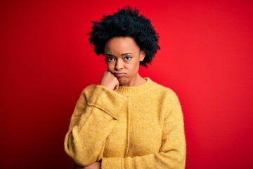 Fototapeta na wymiar Young beautiful African American afro woman with curly hair wearing casual yellow sweater thinking looking tired and bored with depression problems with crossed arms.