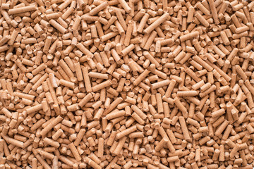 Wooden pellets background, pattern. Close up natural wood pellet. Ecological heating, renewable energy Biofuels. Top view. Flat lay ecological fuel for solid fuel boilers.