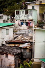 Laundry hangs on a line in a decaying neighborhood in Hong Kong.