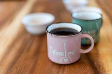 Cup of brewed black coffe on the wooden table
