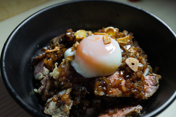 Soft boiled egg on top of roast beef.