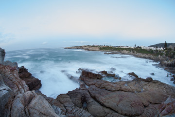 The cold waters of the Atlantic Ocean wash against the rugged coastline near Simon's Town, South Africa. This beautiful area is not far from Cape Town and is a favorite tourist destination.