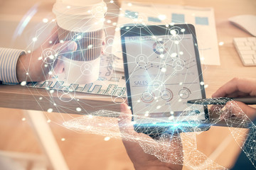 Double exposure of man's hands holding and using a phone and social network theme drawing.