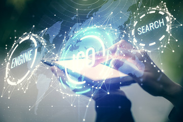 Double exposure of blockchain business sketch hologram and woman holding and using a mobile device.
