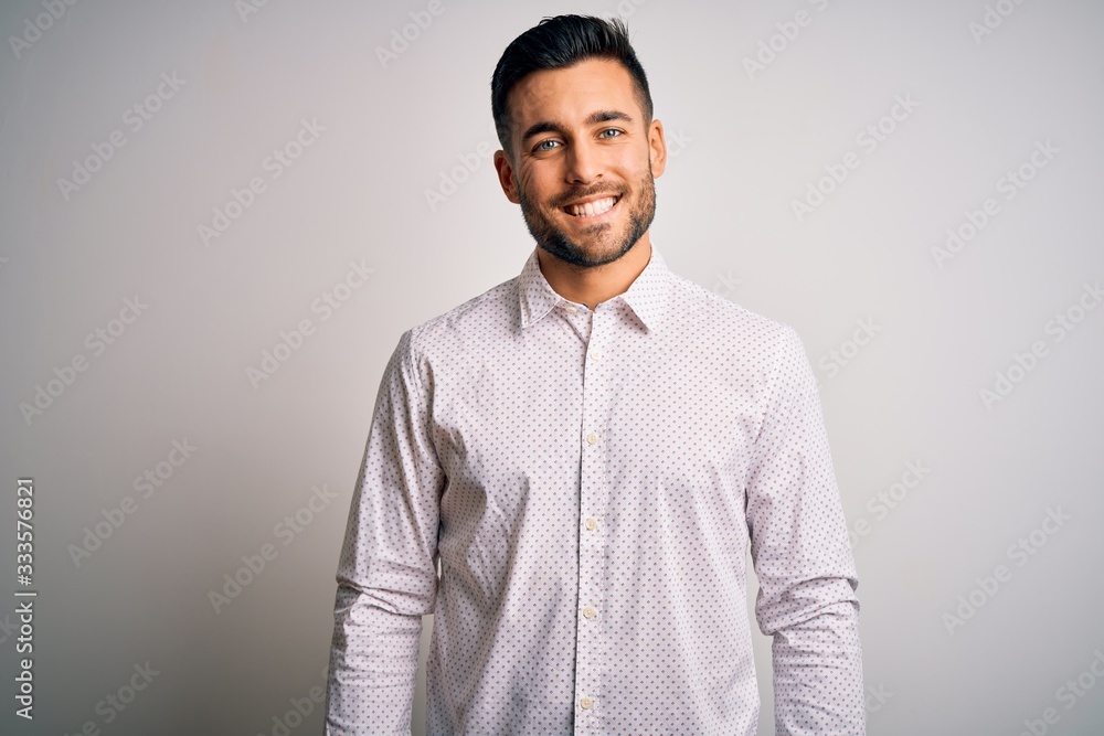 Sticker Young handsome man wearing elegant shirt standing over isolated white background with a happy and cool smile on face. Lucky person.