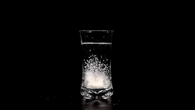 Vitamins Fizzy tablet in a glass of water