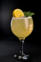 delicious drink with citrus fruit cocktail with ice in glass cup on colorful background,