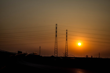Fototapeta na wymiar Sunset on the background of the road and antennas. Beautiful landscape. Background.