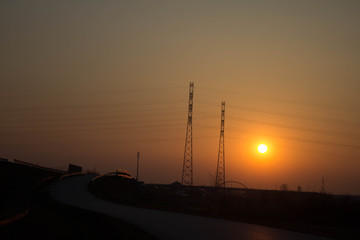 Fototapeta na wymiar Sunset on the background of the road and antennas. Beautiful landscape. Background.