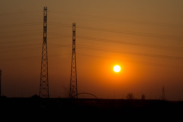 Fototapeta premium Sunset on the background of the road and antennas. Beautiful landscape. Background.