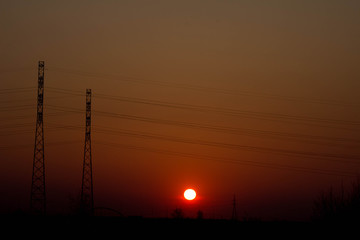 Sunset on the background of the road and antennas. Beautiful landscape. Background.