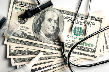 Stethoscope on a background of money - a business concept in medicine, a bribe to a doctor....